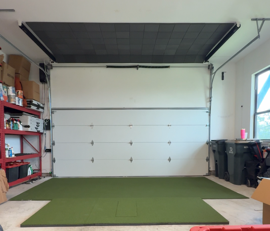 Retractable screen raised in a garage so the space stays usable