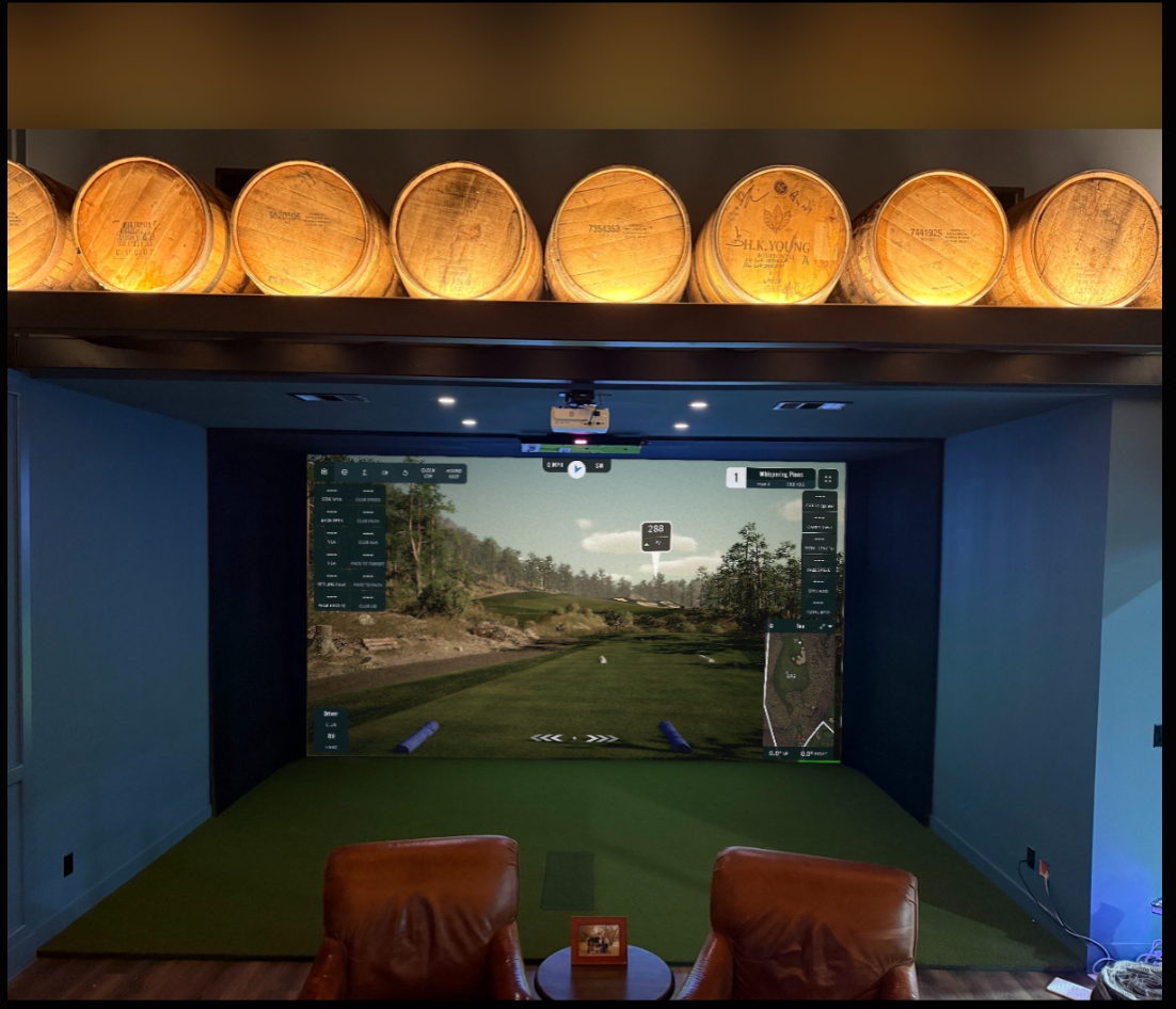 Built in simulator bay in a lounge with seating and accent lighting
