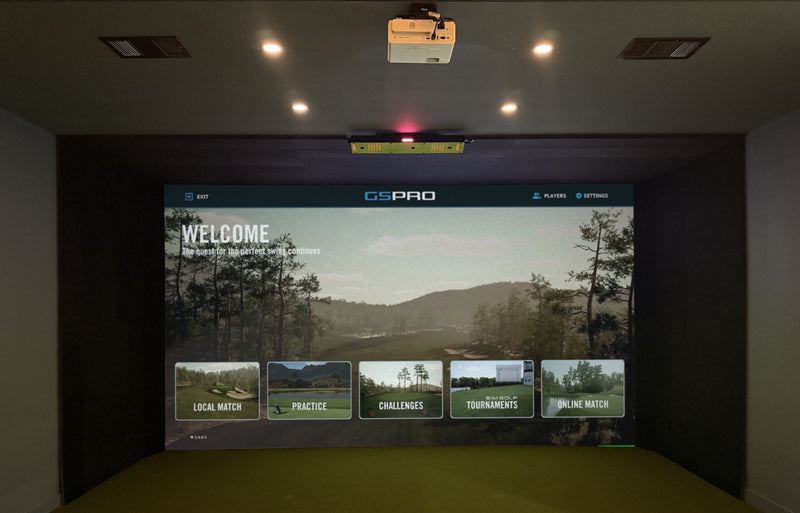 Golf simulator room with GSPro on the impact screen